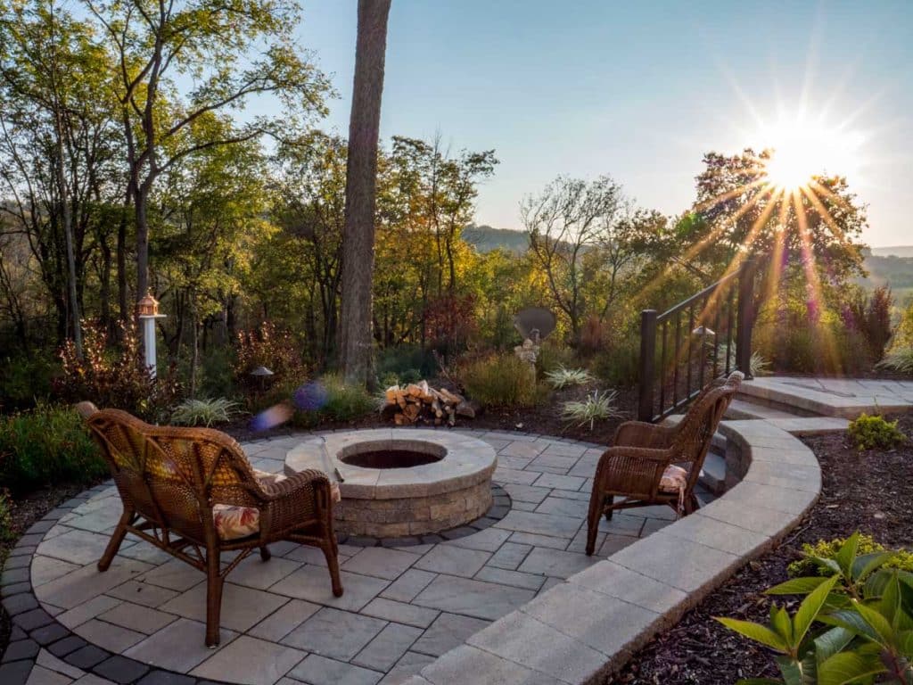 A patio with a fire pit in the sun.