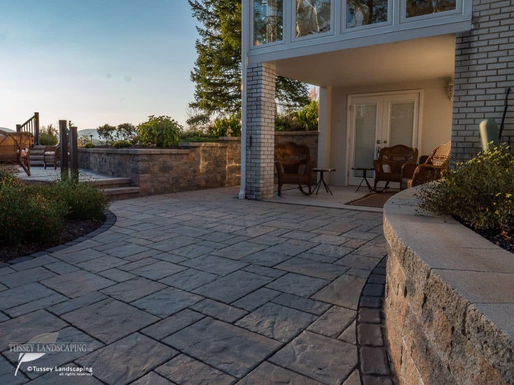 A patio with stone pavers and a fire pit.