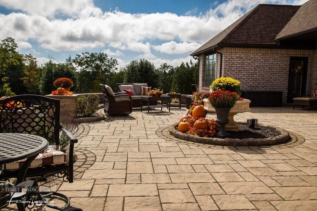 A patio with patio furniture and pumpkins.