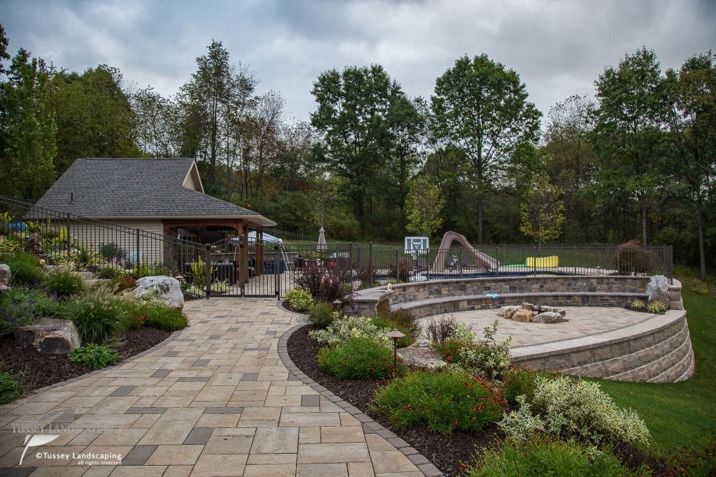 A backyard with a fire pit and landscaping.