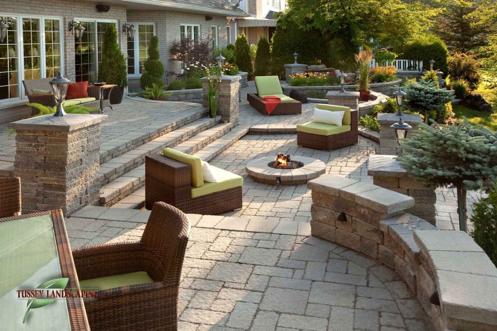 A patio with seating and a fire pit.