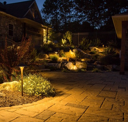 Landscape lighting at night in a stone walkway.