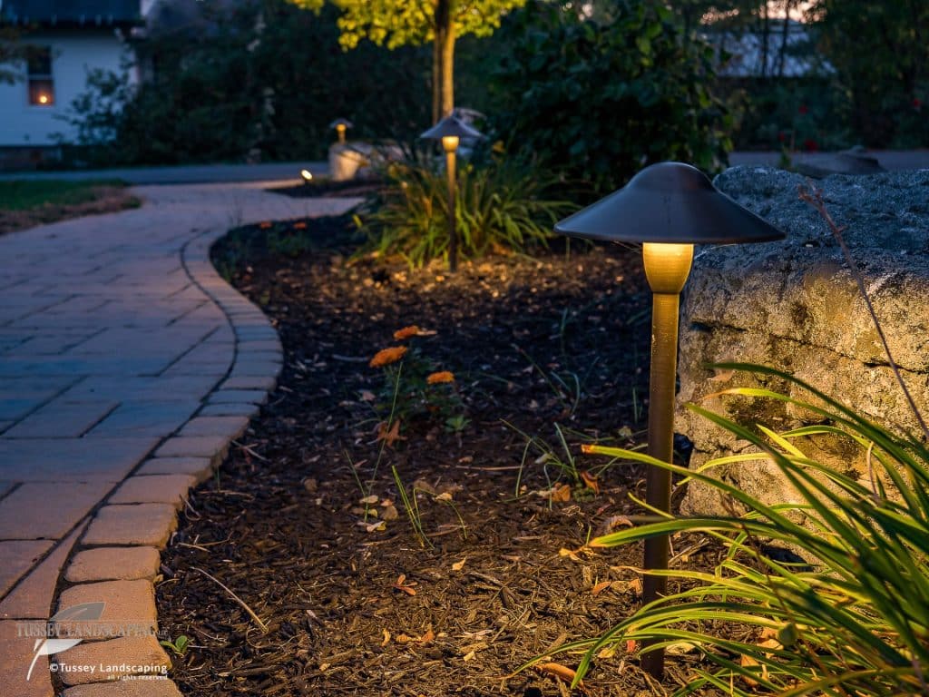 A walkway lit up at dusk.