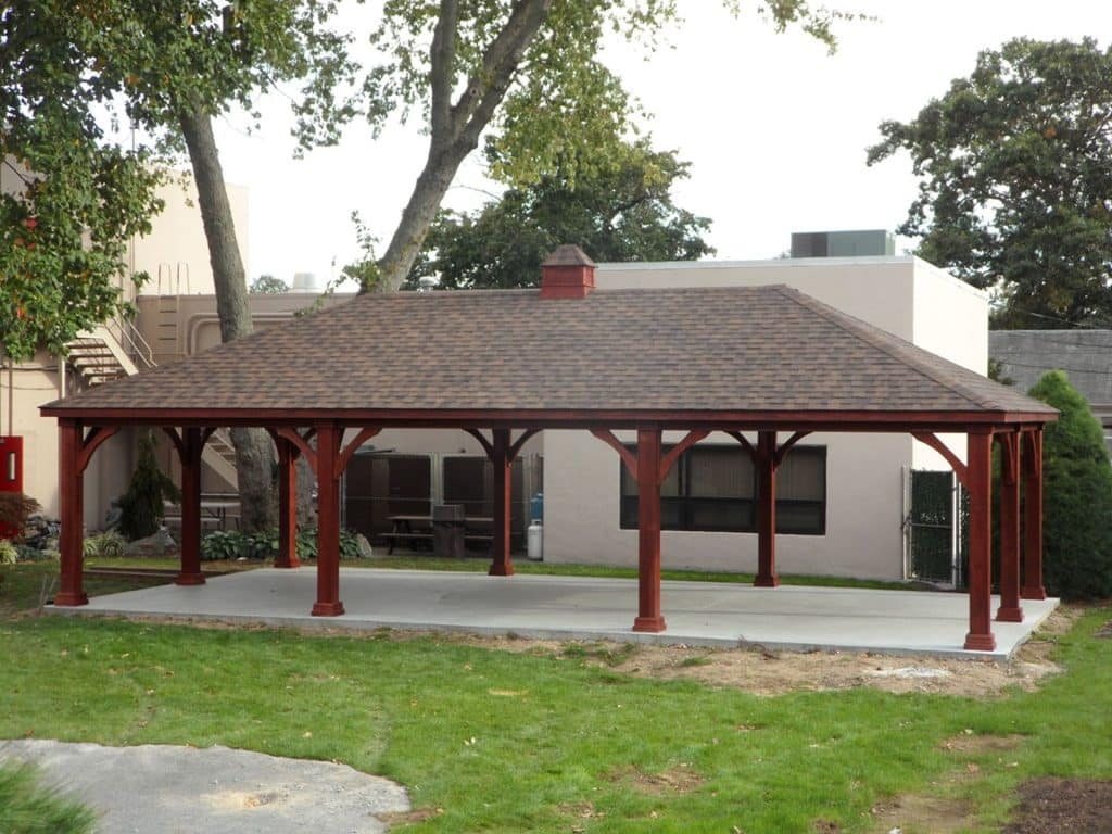 A wooden gazebo with a roof.