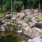Large waterfall with landscaping and pond