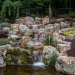 Large waterfall with landscaping and pond
