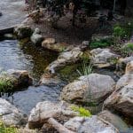 Large waterfall with landscaping and pond