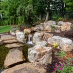 Large waterfall with landscaping and pond