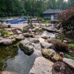 Large waterfall with landscaping and pond