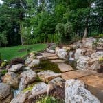 Large waterfall with landscaping and pond