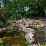 Large waterfall with landscaping and pond