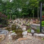 Large waterfall with landscaping and pond