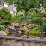 waterfall with pond and landscaping and hardscaping