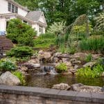 waterfall with pond and landscaping and hardscaping