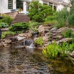 waterfall with pond and landscaping and hardscaping