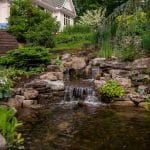 waterfall with pond and landscaping and hardscaping