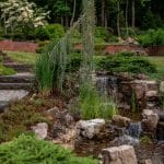 waterfall with pond and landscaping and hardscaping