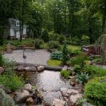 waterfall with pond and landscaping and hardscaping