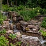 waterfall with pond and landscaping and hardscaping