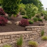 multi level retaining wall with landscaping and paver driveway