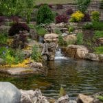 outdoor living space with pool, patio, pergola, pavilion, hot tub, pond