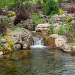 outdoor living space with pool, patio, pergola, pavilion, hot tub, pond