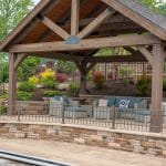 outdoor living space with pool, patio, pergola, pavilion, hot tub, pond