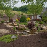 water feature with pond and waterfalls and mountain boulders