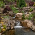 water feature with pond and waterfalls and mountain boulders