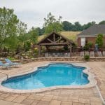 outdoor living space with pool, patio, pergola, pavilion, hot tub, pond