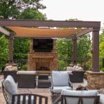 wooden pergola with paver patio and fireplace