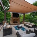 wooden pergola with paver patio and fireplace