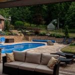 outdoor living space with fiberglass swimming pool, pergola, and paver patio