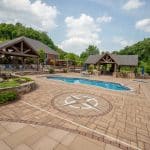 outdoor living space with pool, patio, pergola, pavilion, hot tub, pond