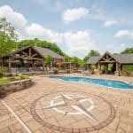 outdoor living space with pool, patio, pergola, pavilion, hot tub, pond