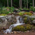 waterfall with mountain boulders and landscaping