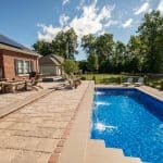 fiberglass swimming pool, spa hot tub, with hardscaping and paver patio