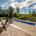 fiberglass swimming pool, spa hot tub, with hardscaping and paver patio