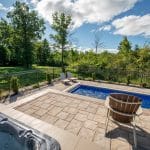 fiberglass swimming pool, spa hot tub, with hardscaping and paver patio