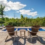 fiberglass swimming pool, spa hot tub, with hardscaping and paver patio