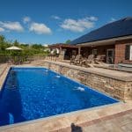 fiberglass swimming pool, spa hot tub, with hardscaping and paver patio
