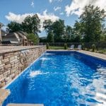 fiberglass swimming pool, spa hot tub, with hardscaping and paver patio