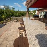 paver patio with outdoor kitchen under a pergola