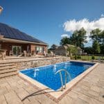 fiberglass swimming pool, spa hot tub, with hardscaping and paver patio
