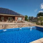 fiberglass swimming pool, spa hot tub, with hardscaping and paver patio
