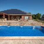 fiberglass swimming pool, spa hot tub, with hardscaping and paver patio