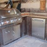 outdoor kitchen with granite counters and stainless steel appliances