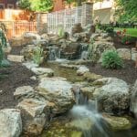 water feature in backyard with stream and waterfalls