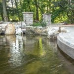 pond with over look edge and paver patio
