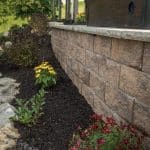 retaining wall with mulch landscaping beds